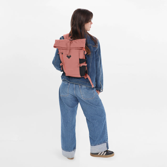 Woman wearing a Sherpani Sedona Desert Pink Backpack on her back against white background. #color_desert-pink