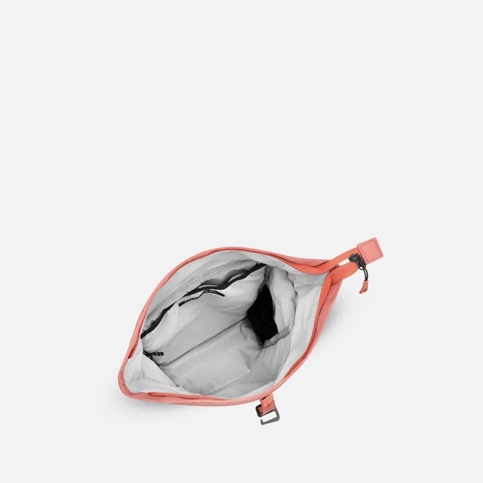 A Sherpani Sedona Desert Pink Backpack, above view showing inside the main compartment on white backdrop.  #color_desert-pink