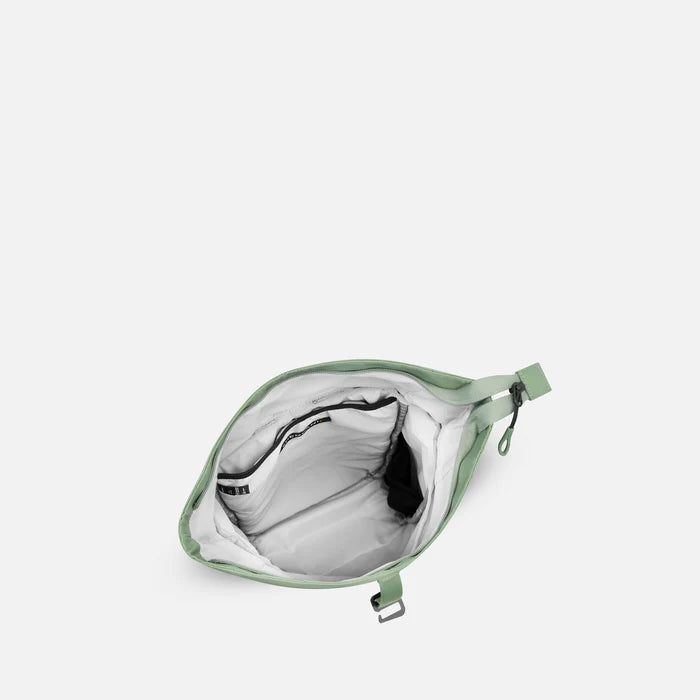 A Sherpani Sedona Olivine Backpack, above view showing inside the main compartment on white backdrop.  #color_olivine-green