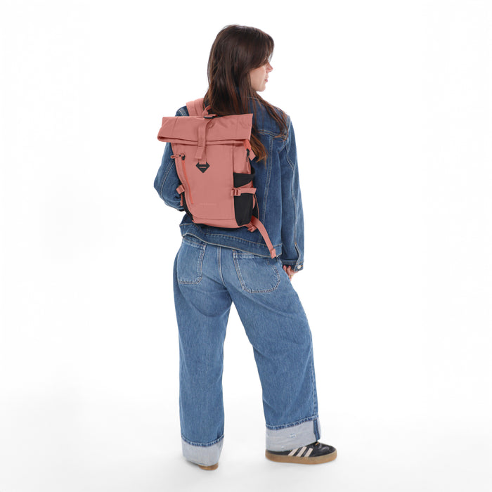 Woman wearing a Sherpani Sedona Desert Pink Backpack on her back against white background. #color_desert-pink