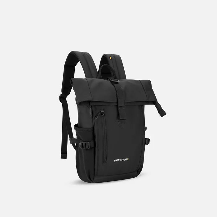 A Sherpani Sedona Raven Black Backpack, 3/4 view showing buckled pockets and straps on white background.   #color_raven-black