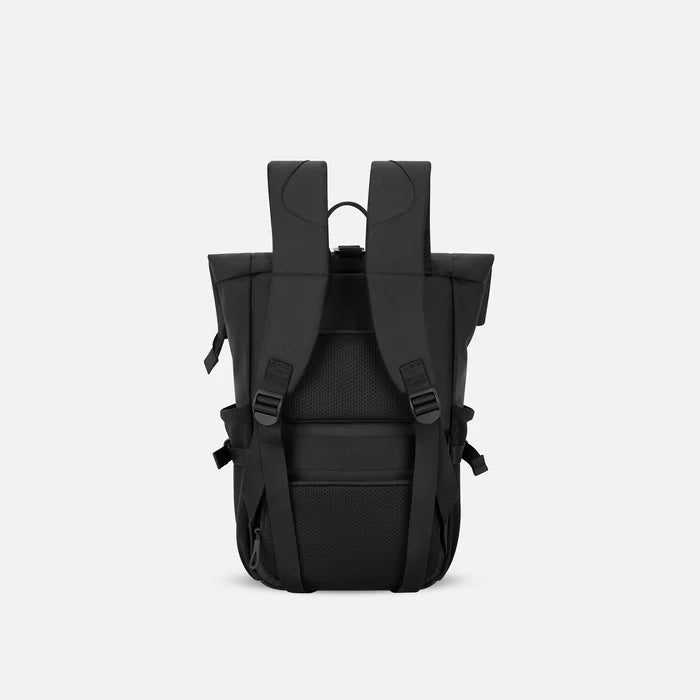 A Sherpani Sedona Raven Black Backpack, back view showing shoulder straps and luggage strap on white background. #color_raven-black