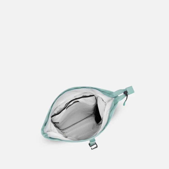 A Sherpani Sedona Surf Blue Backpack, above view showing inside the main compartment on white backdrop.  #color_surf-blue
