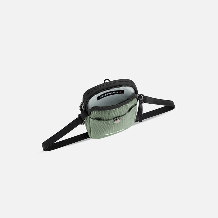 A Sherpani Simplicity Aloe Mist Green Anti-Theft Crossbody Wallet, above view showing the inside pockets on white background.#color_aloe-mist-green