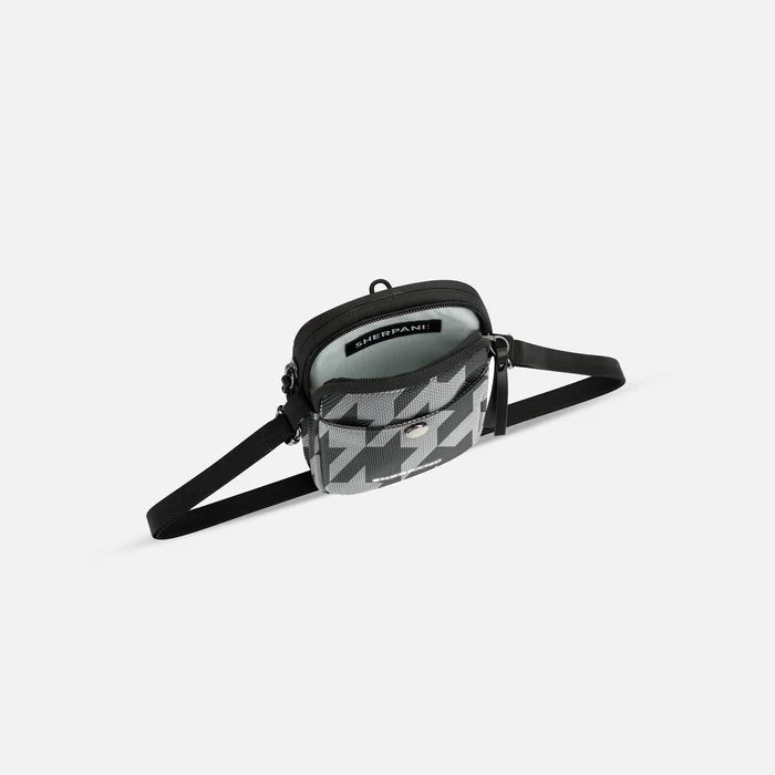 A Sherpani Simplicity Houndstooth Anti-Theft Crossbody Wallet, above view showing inside main pocket on a white background.   #color_houndstooth-print