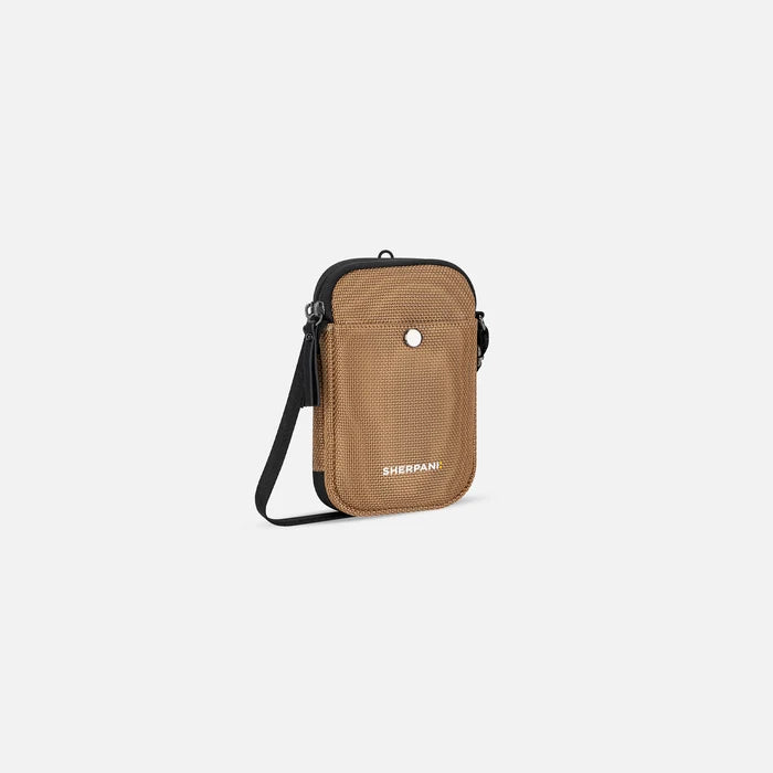 A Sherpani Simplicity Sand Anti-Theft Crossbody Wallet, 3/4 view showing main pocket and strap on a white background. #color_sand-tan
