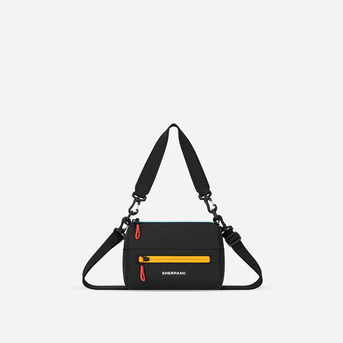 A Sherpani Chromatic Black Shoulder Bag, front view showing lockable pocket and strap options on white backdrop.  #color_chromatic-black
