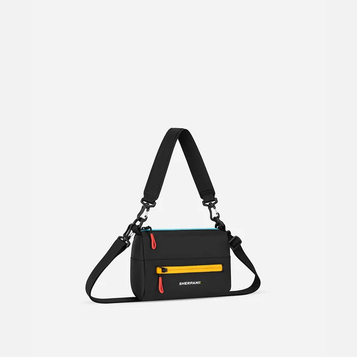 A Sherpani Skye Chromatic Black Shoulder Bag, 3/4 view showing lockable pocket and strap options on white backdrop.  #color_chromatic-black