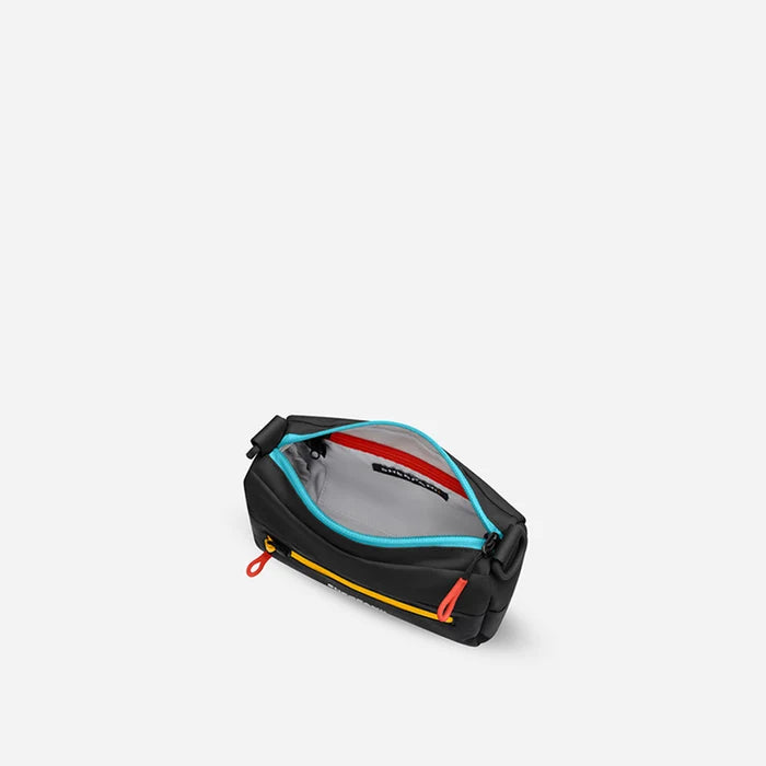 A Sherpani Skye Chromatic Black Shoulder Bag, above view showing inside pockets on a white backdrop. #color_chromatic-black