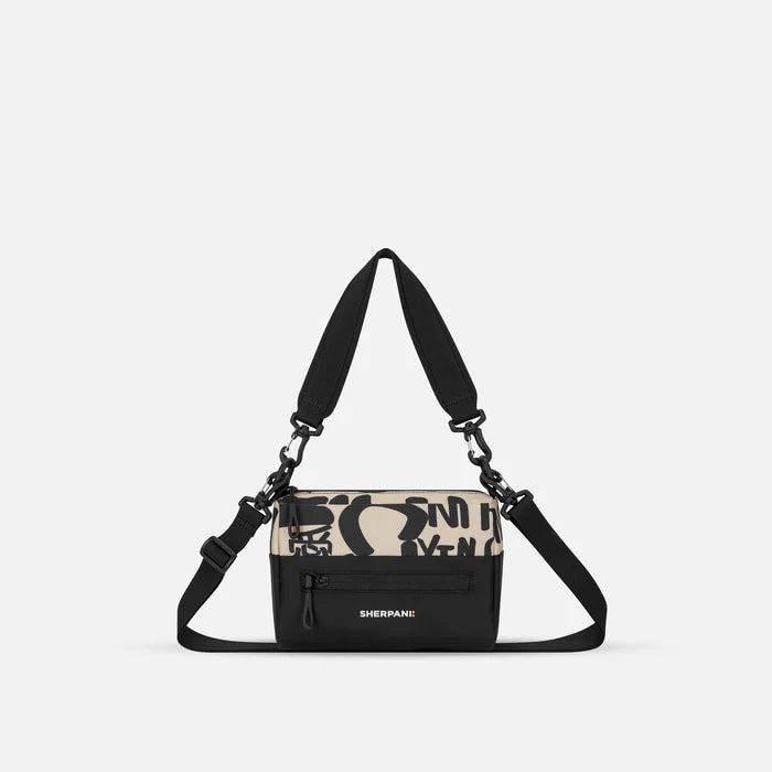 A Sherpani Ciao Shoulder Bag, front view showing lockable pocket and strap options on white backdrop.  #color_ciao-print