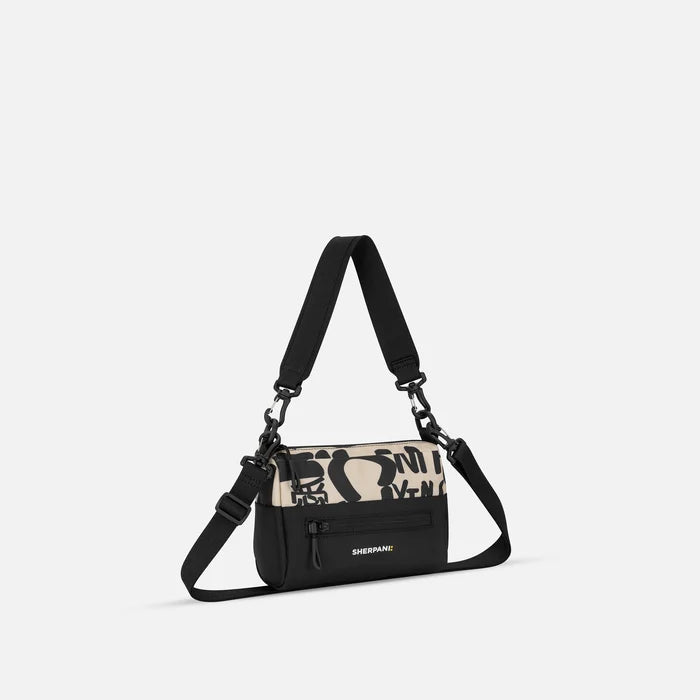 A Sherpani Skye Ciao Shoulder Bag, 3/4 view showing lockable pocket and strap options on white backdrop.  #color_ciao-print