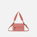 A Sherpani Desert Pink Shoulder Bag, front view showing lockable pocket and strap options on white backdrop.  #color_desert-pink