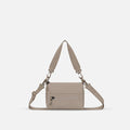 A Sherpani Dune Shoulder Bag, front view showing lockable pocket and strap options on white backdrop.  #color_dune-tan