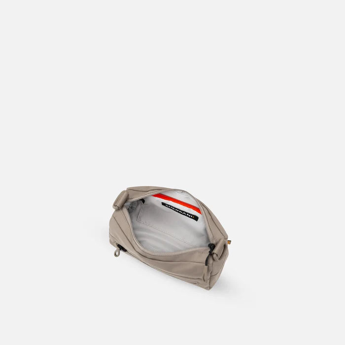 A Sherpani Skye Dune Shoulder Bag, above view showing inside pockets on a white backdrop. #color_dune-tan