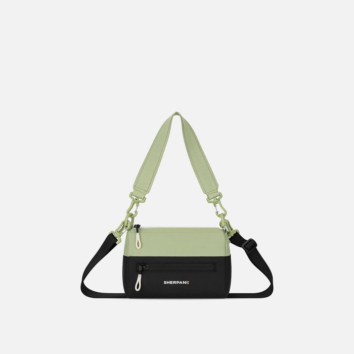 A Sherpani Palm Green Shoulder Bag, front view showing lockable pocket and strap options on white backdrop. #color_palm-green