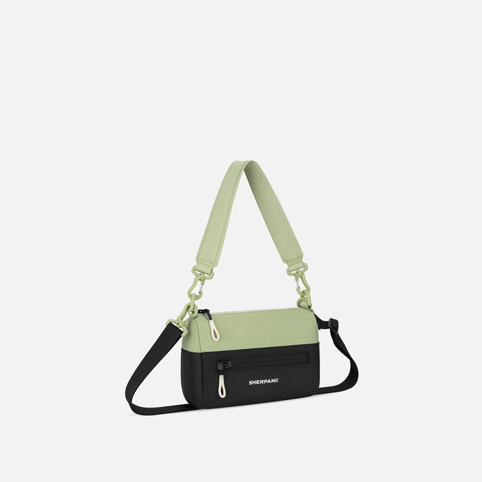 A Sherpani Skye Palm Green Shoulder Bag, 3/4 view showing lockable pocket and strap options on white backdrop. #color_palm-green