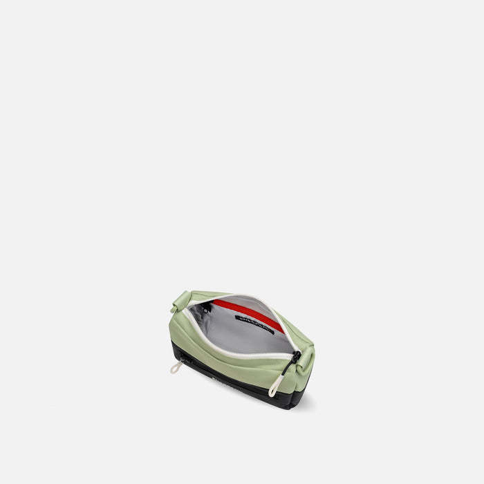 A Sherpani Skye Palm Green Shoulder Bag, above view showing inside pockets on a white backdrop. #color_palm-green