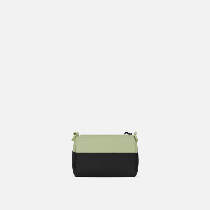 A Sherpani Skye Palm Green Shoulder Bag, back view on a white backdrop. #color_palm-green