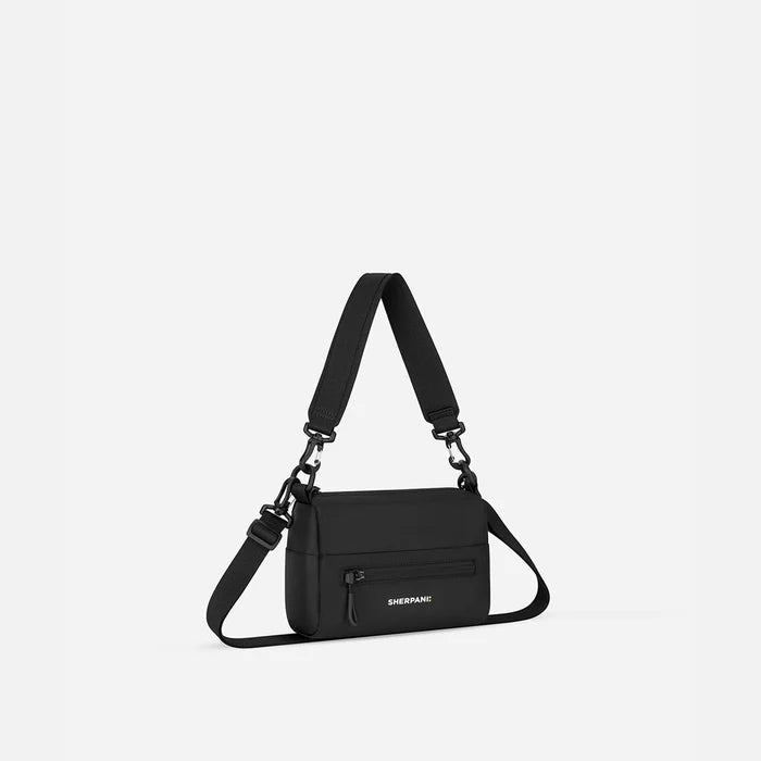 A Sherpani Skye Raven Black Shoulder Bag, 3/4 view showing lockable pocket and strap options on white backdrop.  #color_raven-black