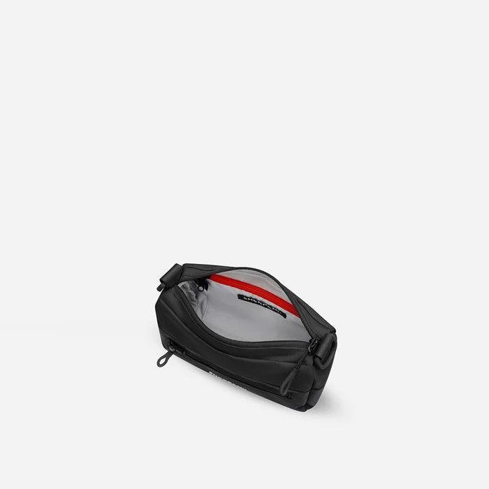 A Sherpani Skye Raven Black Shoulder Bag, above view showing inside pockets on a white backdrop. #color_raven-black