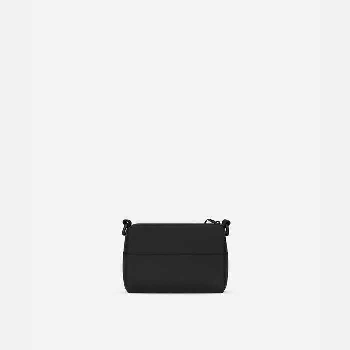 A Sherpani Skye Raven Black Shoulder Bag, back view on a white backdrop.  #color_raven-black