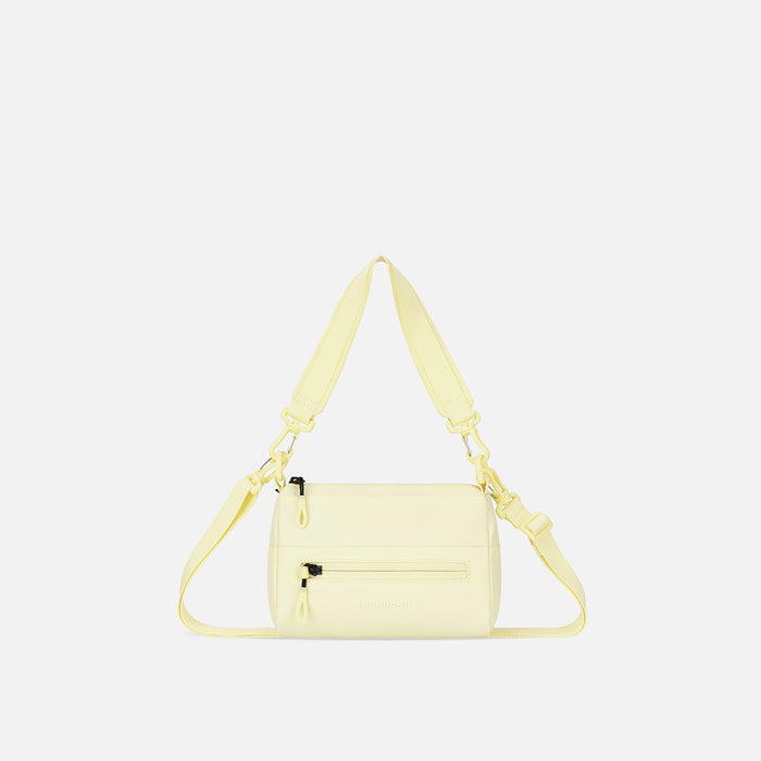 A Sherpani Sol Yellow Shoulder Bag, front view showing lockable pocket and strap options on white backdrop.  #color_sol-yellow