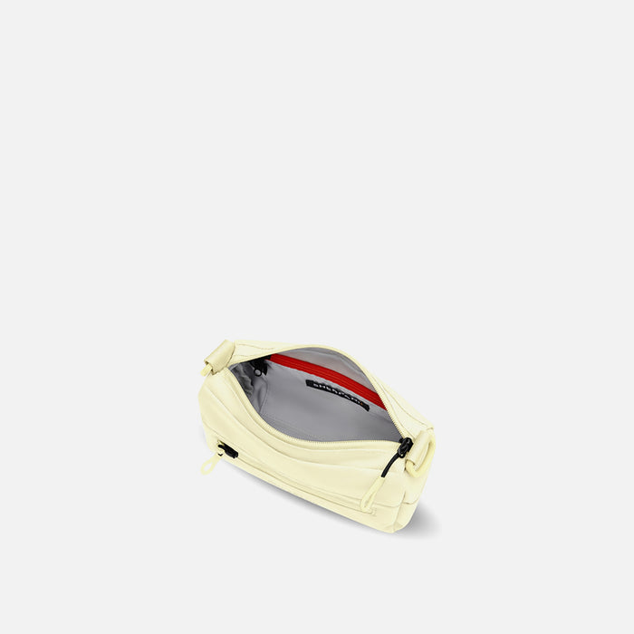 A Sherpani Sol Yellow Shoulder Bag, above view showing inside pockets on a white backdrop. #color_sol-yellow