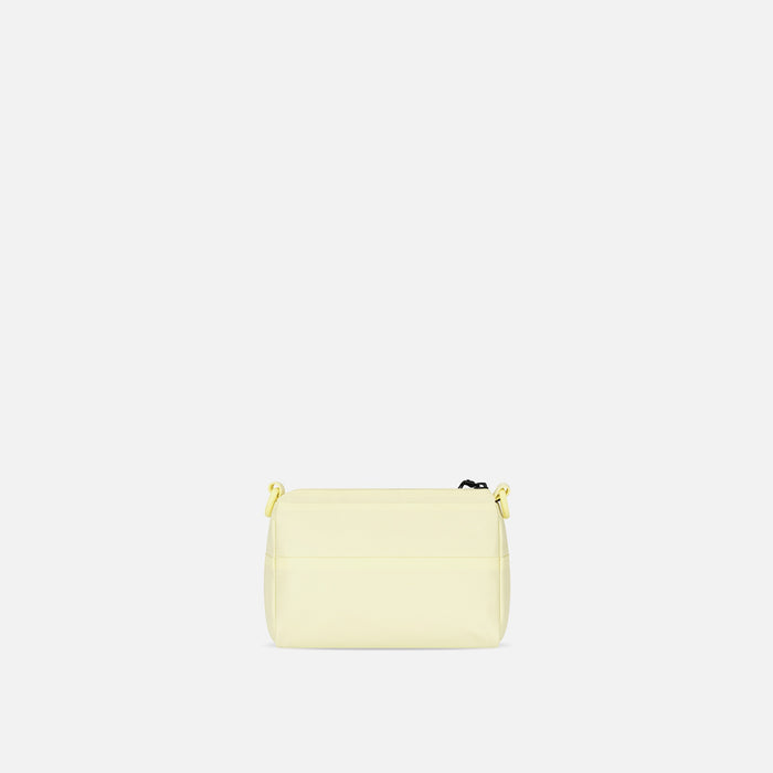 A Sherpani Skye Sol Yellow Shoulder Bag, back view against white backdrop. #color_sol-yellow