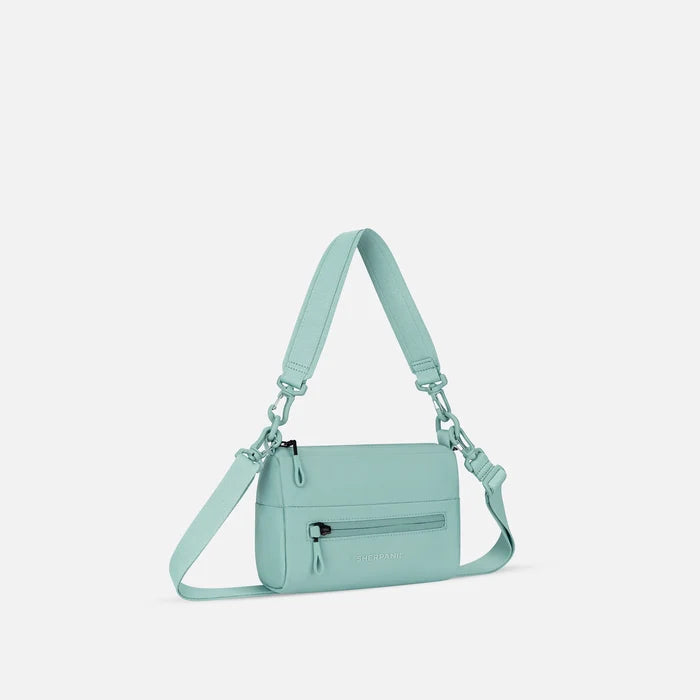 A Sherpani Skye Surf Blue Shoulder Bag, 3/4 view showing lockable pocket and strap options on white backdrop.  #color_surf-blue