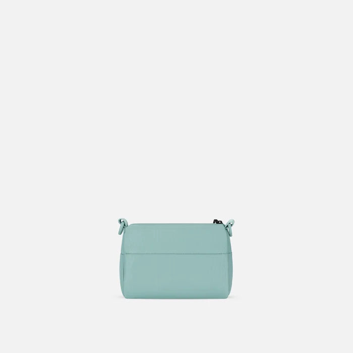 A Sherpani Skye Surf Blue Shoulder Bag, back view on a white backdrop.  #color_surf-blue