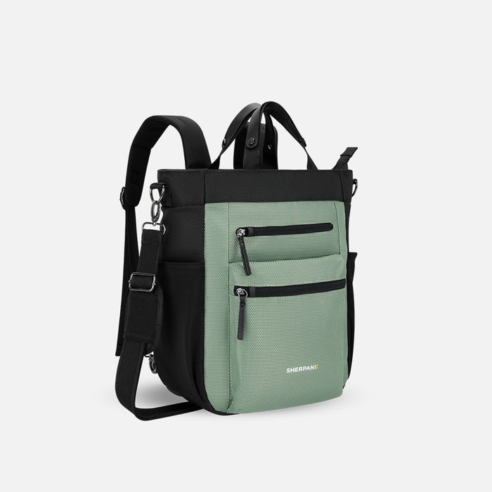 A Sherpani Soleil Aloe Mist Green Anti-theft Multi-Wear Travel Bag, 3/4 view showing lockable pockets and straps on white backdrop. #color_aloe-mist-green
