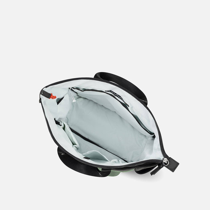 A Sherpani Soleil Aloe Mist Green Anti-theft Multi-Wear Travel Bag, above view showing inside main pocket on white backdrop. #color_aloe-mist-green