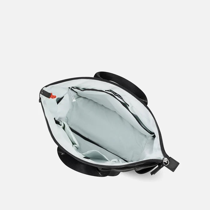 A Sherpani Soleil Carbon Black Anti-theft Multi-Wear Travel Bag, above view showing inside main pocket on white backdrop. #color_carbon-black