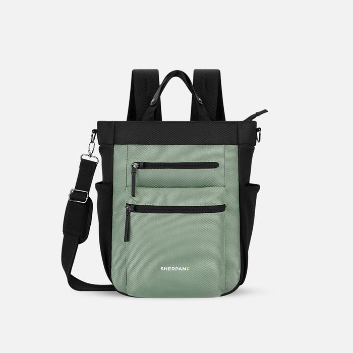A Sherpani Soleil Aloe Mist Green Anti-theft Multi-Wear Travel Bag, front view showing lockable pockets and straps on white backdrop. #color_aloe-mist-green