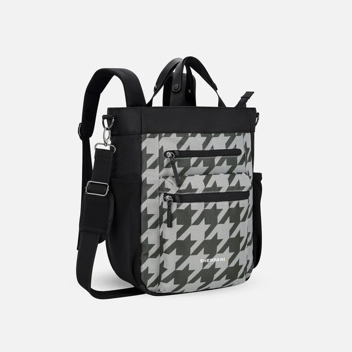 A Sherpani Soleil Houndstooth Anti-theft Multi-Wear Travel Bag, 3/4 view showing lockable pockets and straps on white backdrop. #color_houndstooth-print