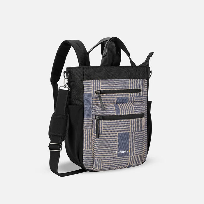 A Sherpani Soleil Passport Anti-theft Multi-Wear Travel Bag, 3/4 view showing lockable pockets and straps on white backdrop. #color_passport-print