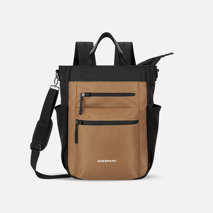 A Sherpani Soleil Sand Anti-theft Multi-Wear Travel Bag, front view showing lockable pockets and straps on white backdrop. #color_sand-tan