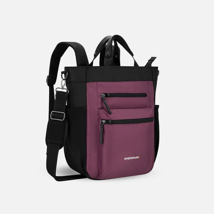 A Sherpani Soleil Smoky Orchid Anti-theft Multi-Wear Travel Bag, 3/4 view showing lockable pockets and straps on white backdrop. #color_smoky-orchid-pink