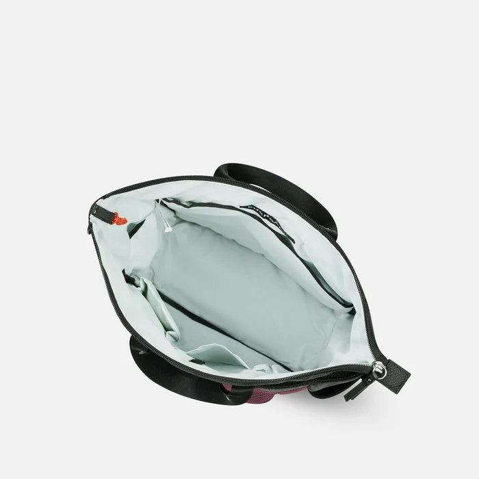 A Sherpani Soleil Smoky Orchid Anti-theft Multi-Wear Travel Bag, above view showing inside main pocket on white backdrop.  #color_smoky-orchid-pink
