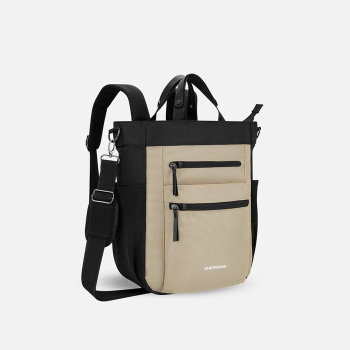 A Sherpani Soleil Straw Beige Anti-theft Multi-Wear Travel Bag, 3/4 view showing lockable pockets and straps on white backdrop. #color_straw-beige