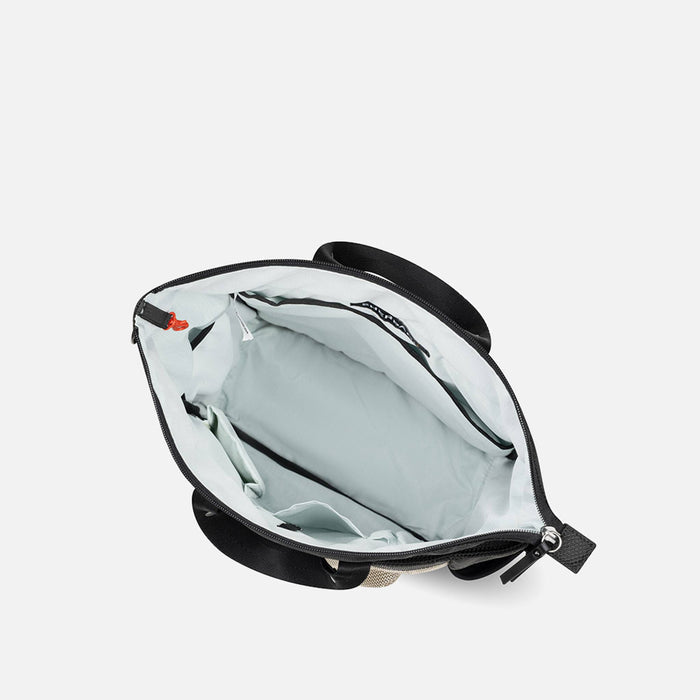 A Sherpani Soleil Straw Beige Anti-theft Multi-Wear Travel Bag, above view showing inside main pocket on white backdrop. #color_straw-beige