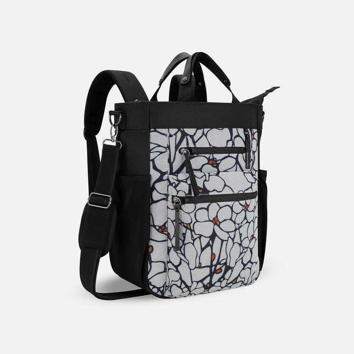 A Sherpani Soleil Sakura Anti-theft Multi-Wear Travel Bag, 3/4 view showing lockable pockets on white backdrop. #color_sakura-signature