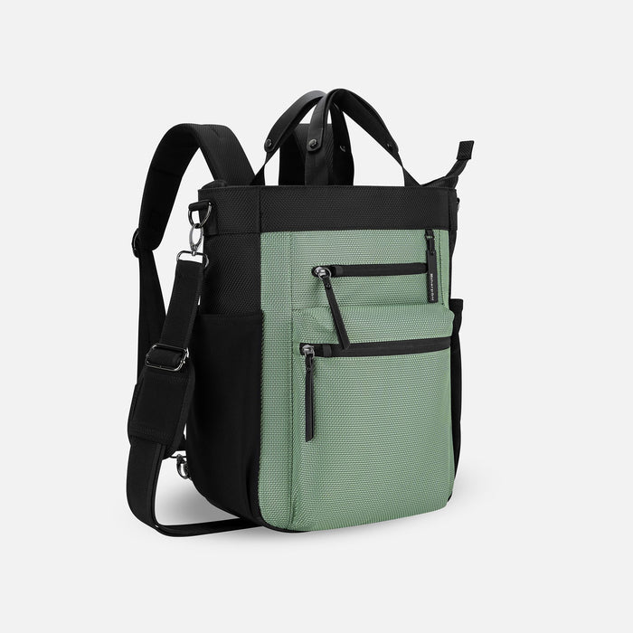 A Sherpani Soleil Aloe Mist Green Anti-theft Multi-Wear Travel Bag, 3/4 view showing lockable pockets on white backdrop. #color_aloe-mist