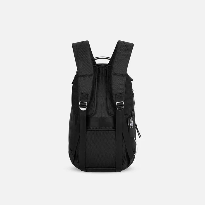 A Sherpani Solstice Carbon Black Anti-Theft Travel Backpack, back view showing back strap pockets and shoulder straps against a white background.   #color_carbon-black