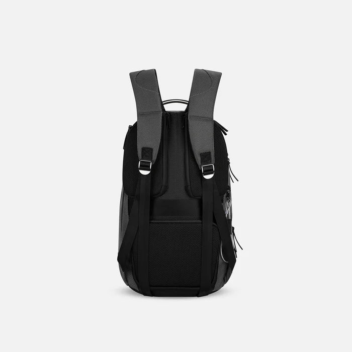 A Sherpani Solstice Granite Anti-Theft Travel Backpack, back view showing back strap pockets and shoulder straps against a white background.  #color_granite-grey