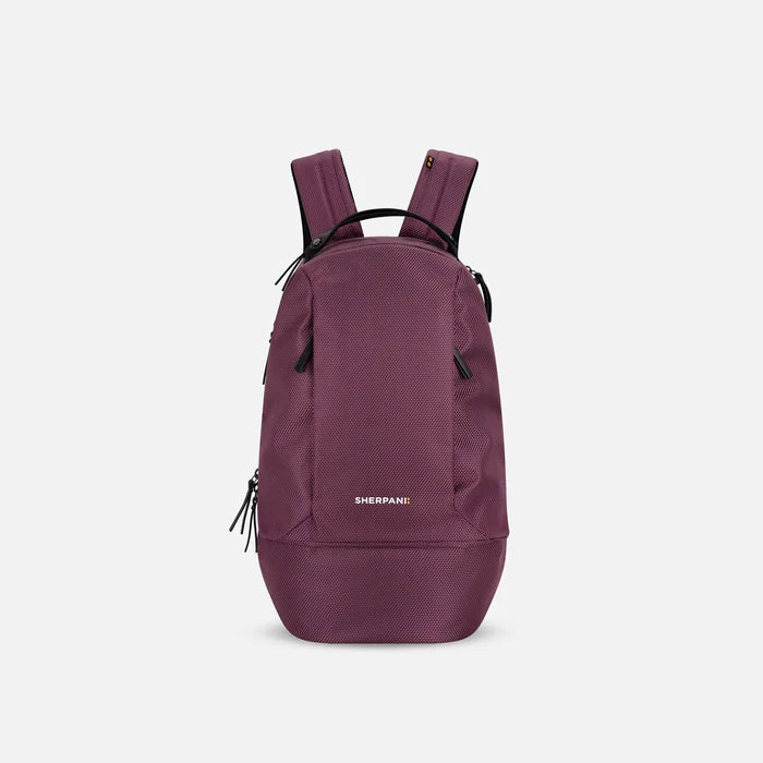 A Sherpani Solstice Smoky Orchid Anti-Theft Travel Backpack, front view showing front pockets and different straps on white background.  #color_smoky-orchid-pink