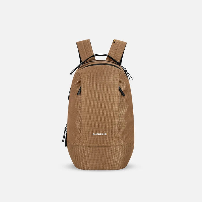 A Sherpani Solstice Sand Tan Anti-Theft Travel Backpack, front view showing front pockets and different straps on white background.  #color_sand-tan