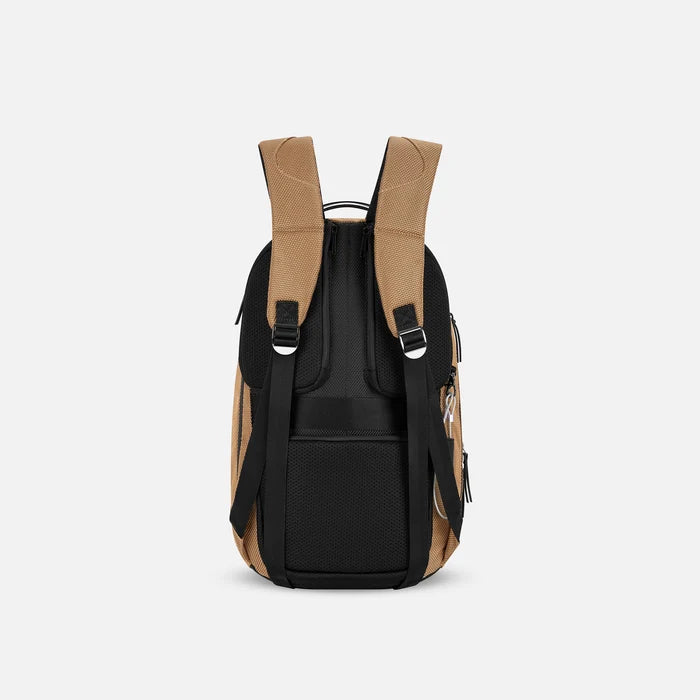 A Sherpani Solstice Sand Tan Anti-Theft Travel Backpack, back view showing back strap pockets and shoulder straps against a white background.   #color_sand-tan