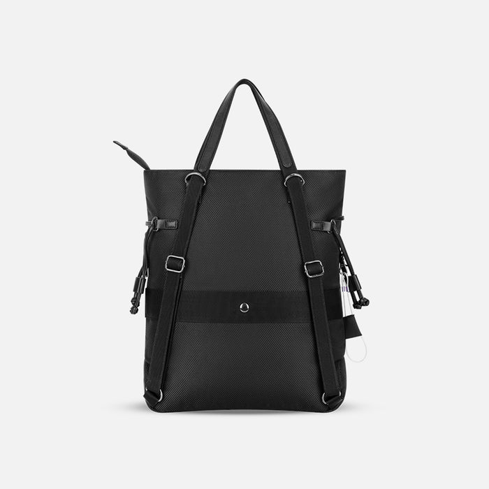 A Sherpani Tempest Carbon Black Convertible Tote, back view showing straps & luggage strap on white background.  #color_carbon-black