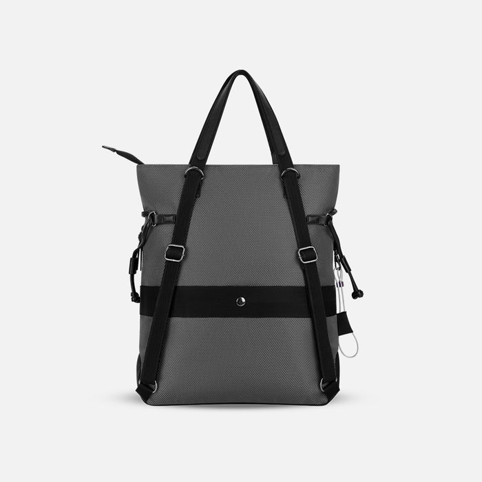 A Sherpani Tempest Granite Grey Convertible Tote, back view showing straps & luggage strap on white background. #color_granite-grey